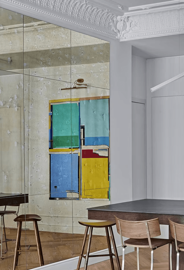 Dining area detail with art and warm wood seating