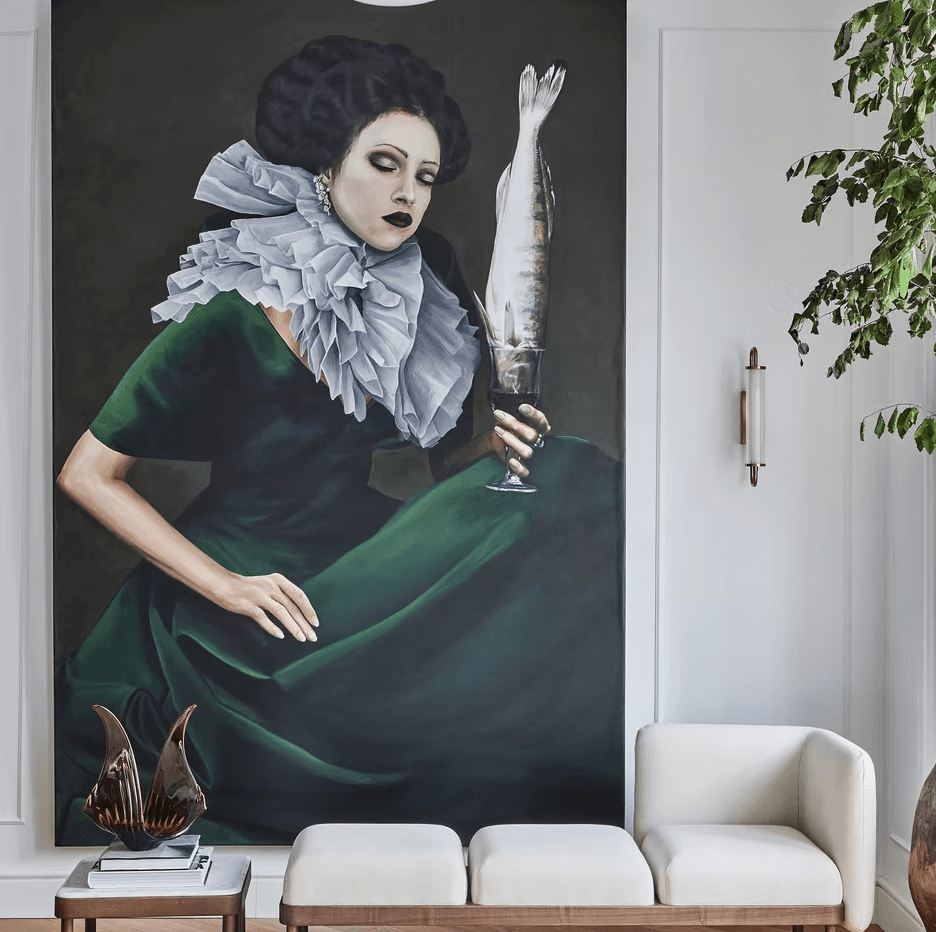 Art wall with large portrait, white lounge seat, plant, and brass sconce