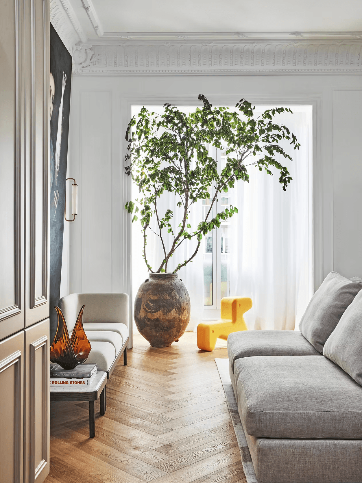 Madrid apartment living room with tall window and sculptural furniture